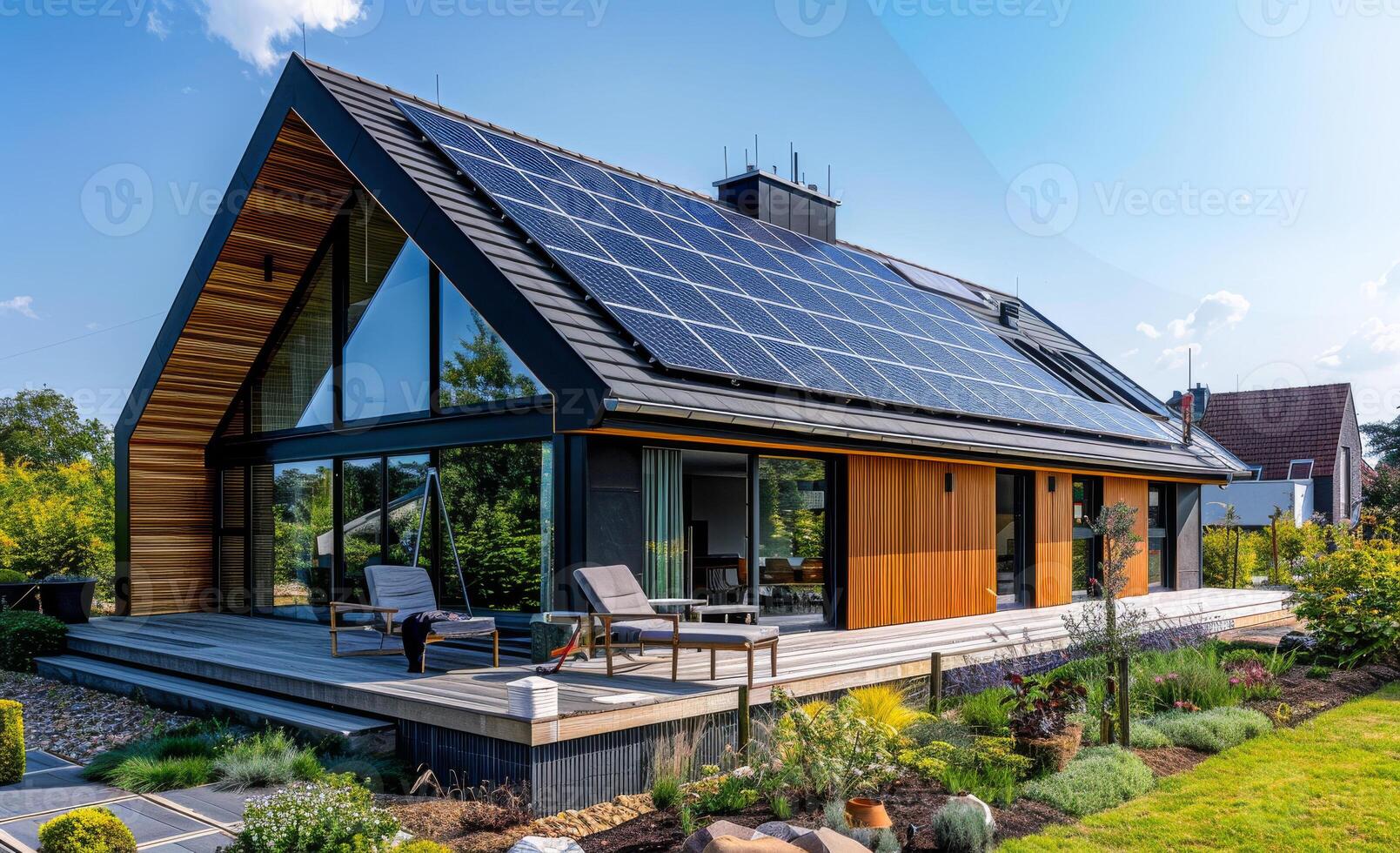 A large house with a lot of windows and a solar panel on the roof photo