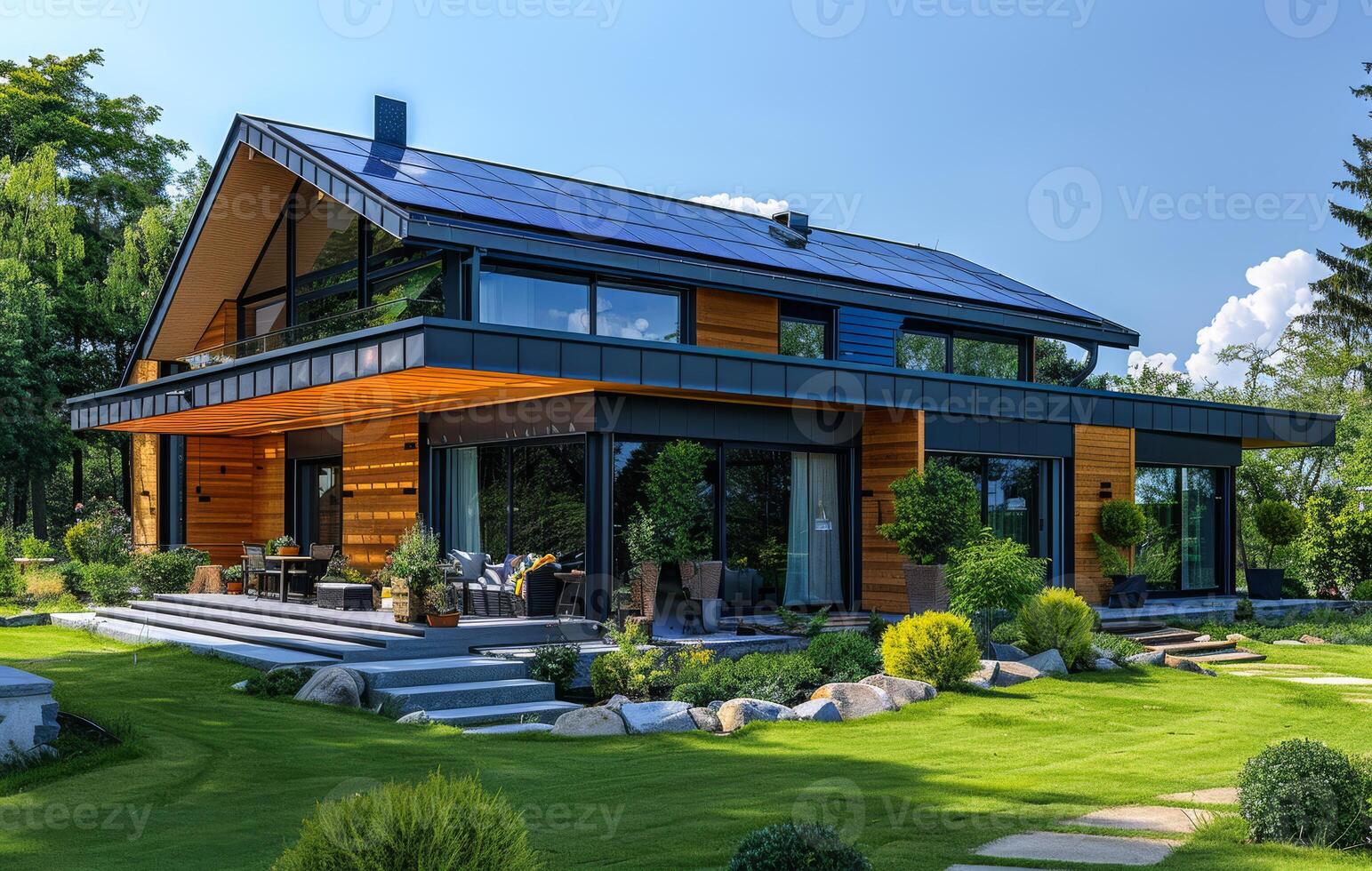 A large house with a lot of windows and a green lawn photo