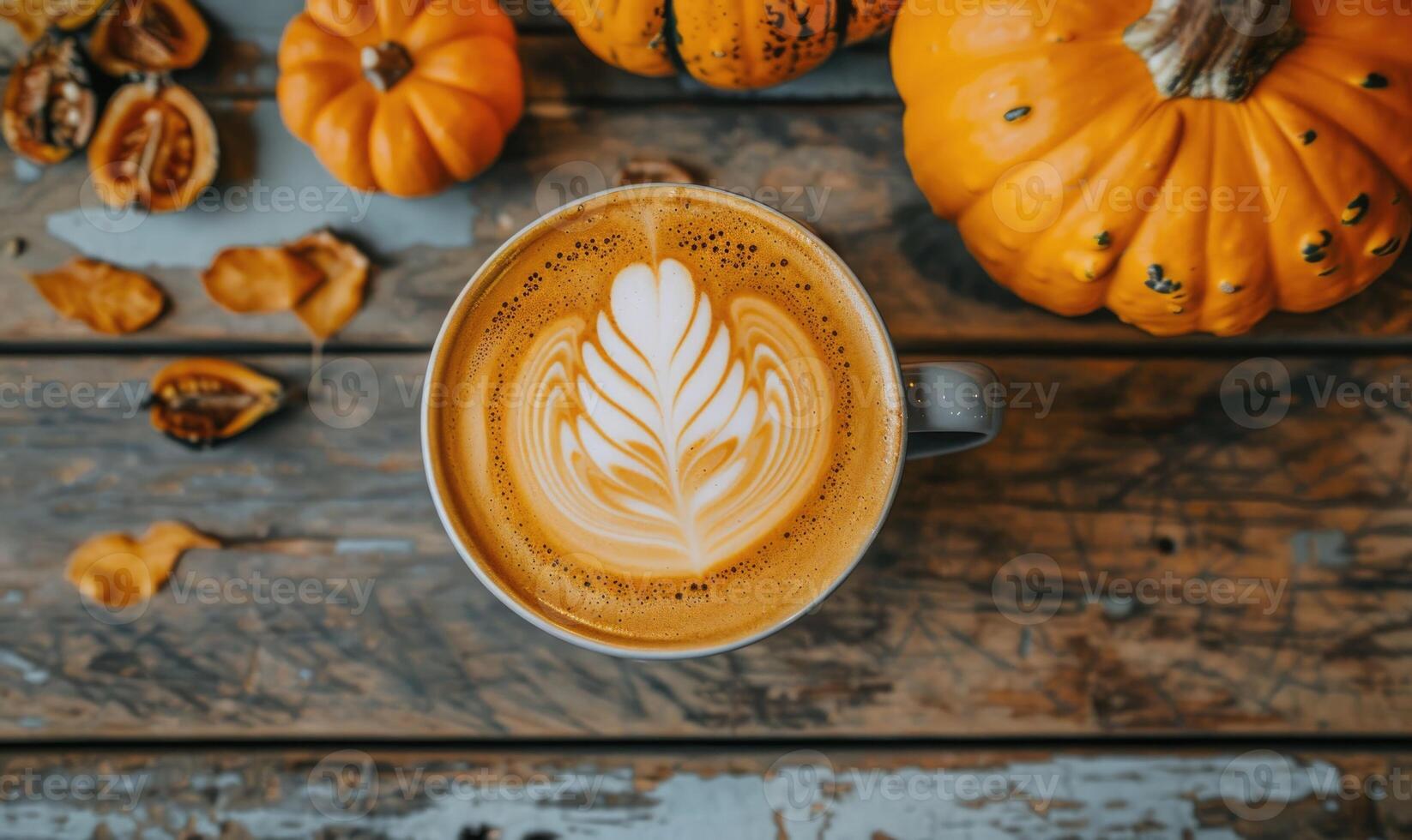 A latte art coffee with pumpkin slices and a pumpkin in the background photo