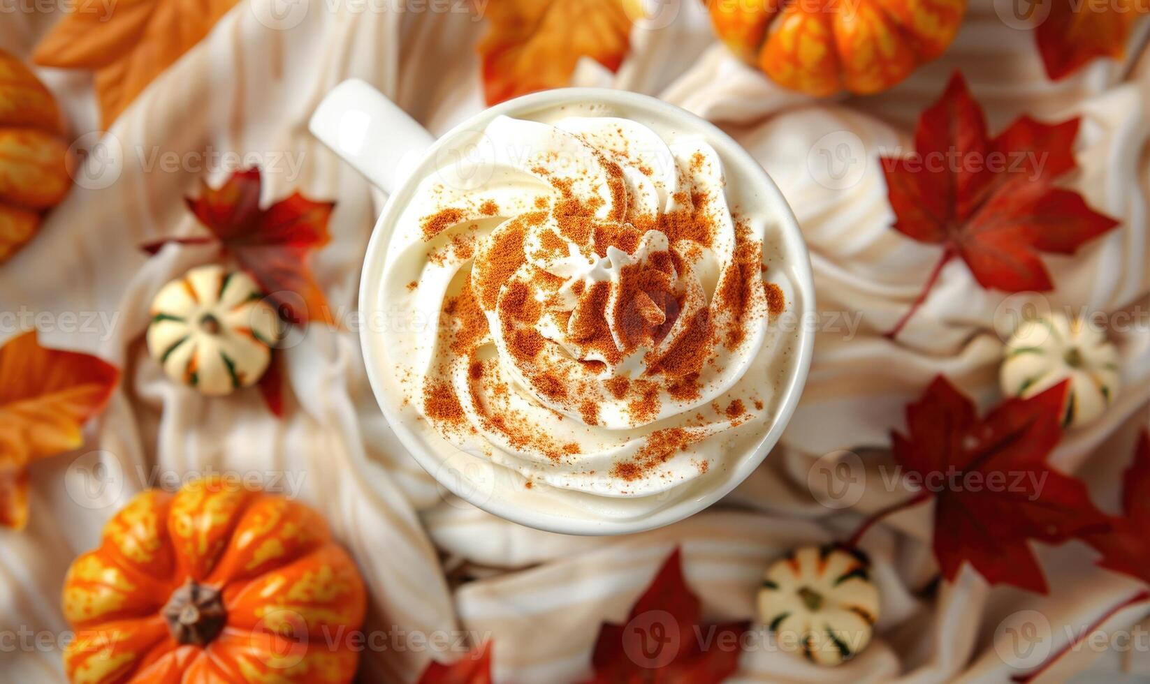 A warm pumpkin chai latte with whipped cream and cinnamon photo