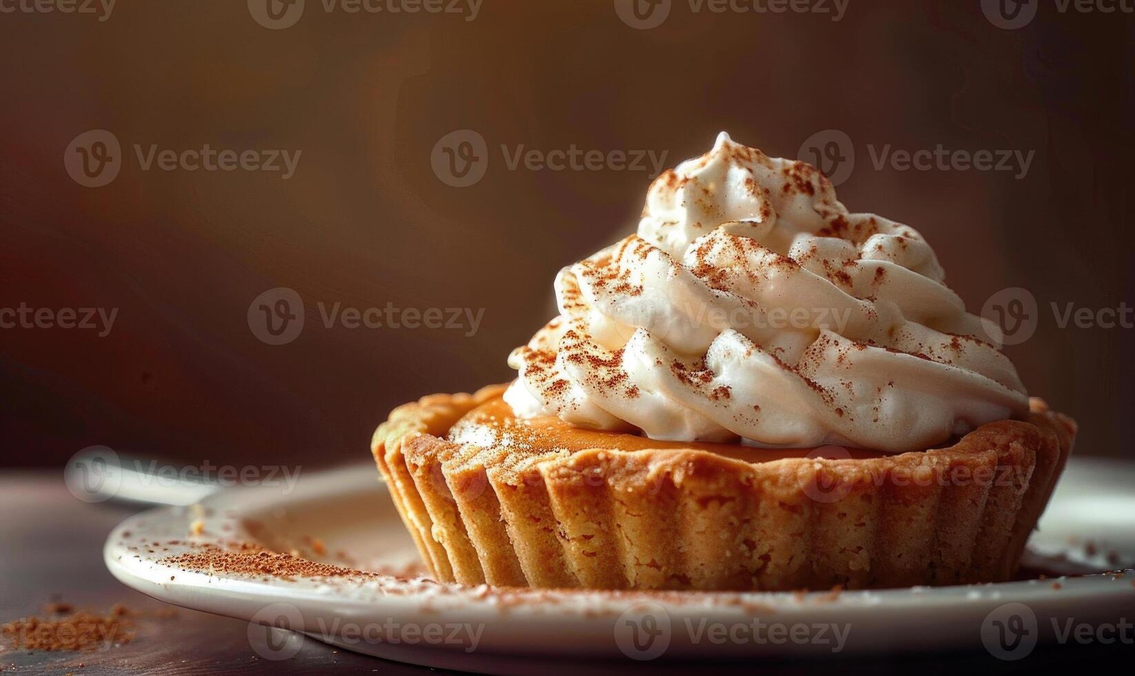 A pumpkin tart with a buttery crust with whipped cream photo