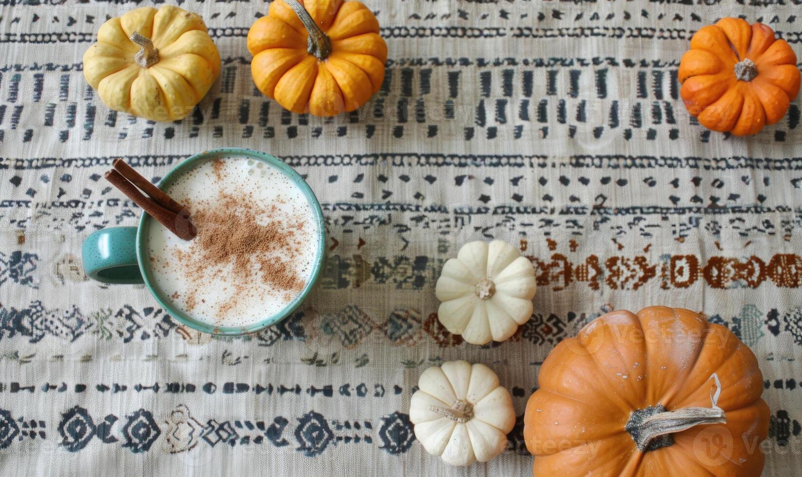A pumpkin spice latte with a cinnamon stick photo