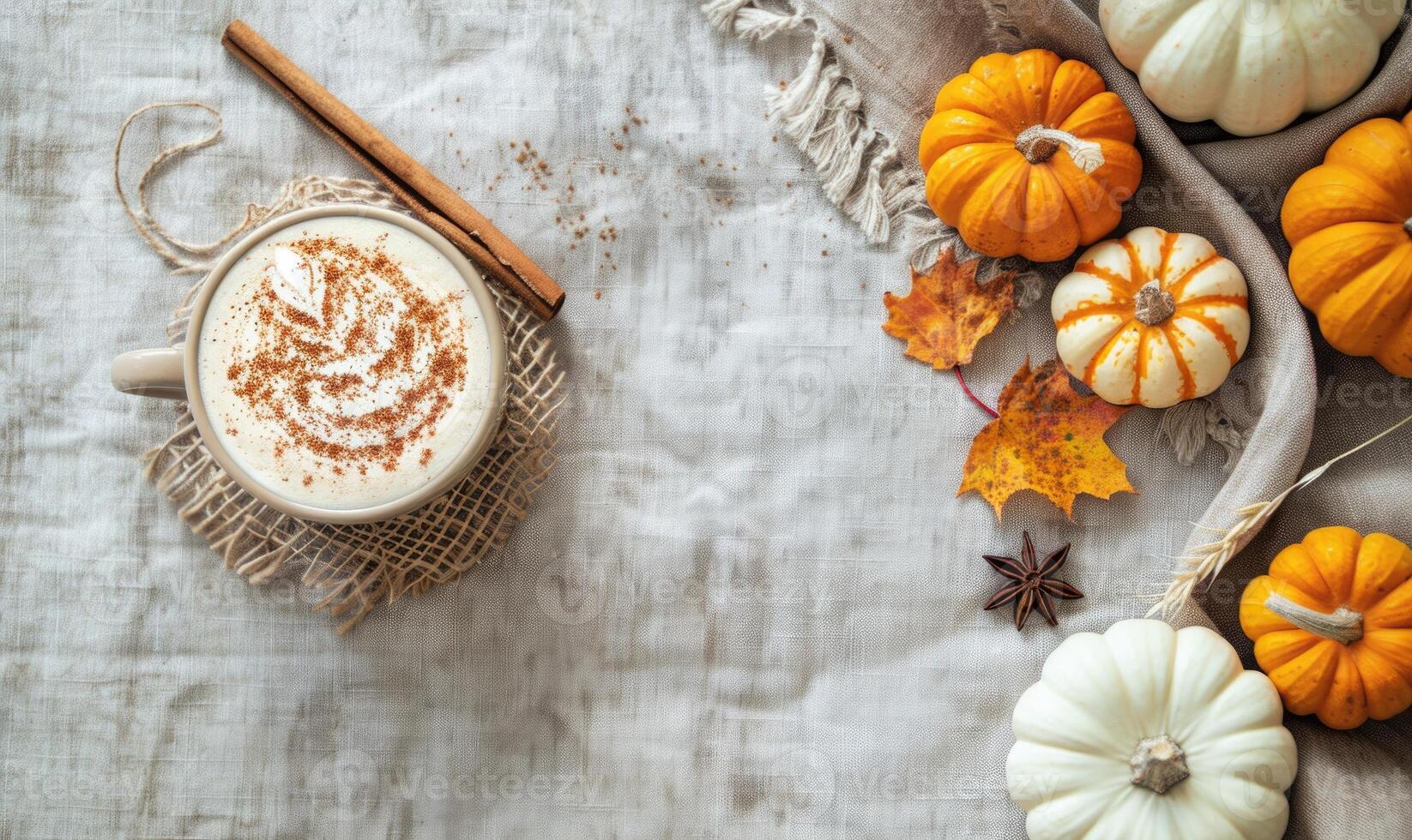 A pumpkin spice latte with a cinnamon stick photo