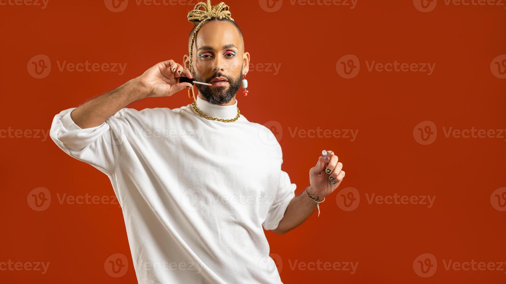 African american gay applying make up isolated on red background photo