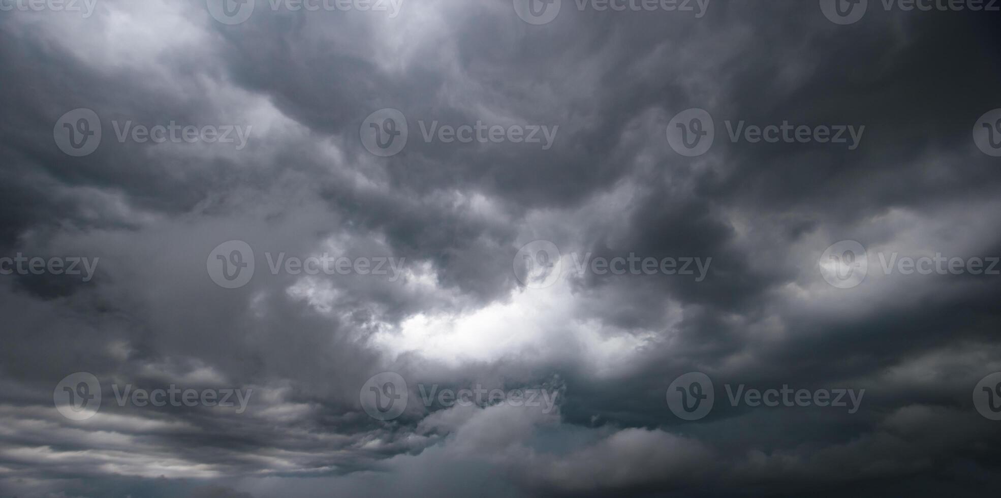 Bad or moody weather sky and environment. climate change. carbon dioxide emissions, greenhouse effect, global warming.The dark sky with heavy clouds converging and a violent storm before the rain. photo