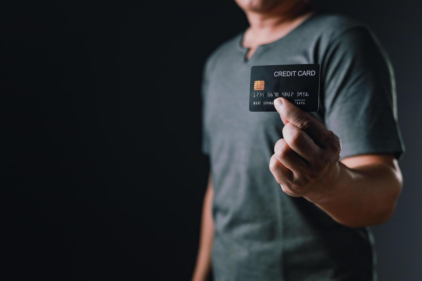 businessman showing a mock-up credit card for business and shopping to make payment and smartphone.half body. purchase, commerce, financial, card, money, using technology. selective focus. photo