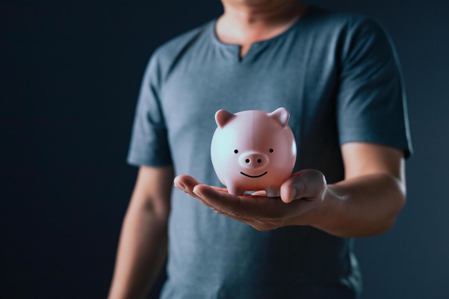 businessman show on the piggy bank on hand, family finance plan concept, fundraising, superannuation, donation, saving, charity, investment, financial crisis concept. photo
