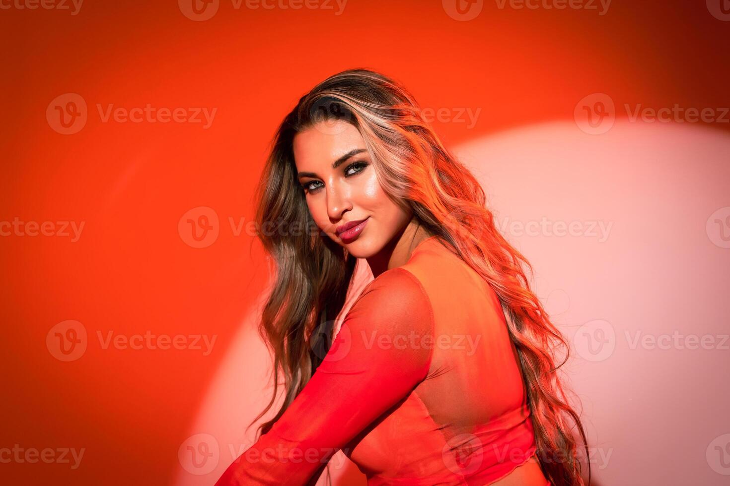 Close-up of a model on an orange background in a blouse with an expressive and penetrating gaze. Banner, poster with place for text photo