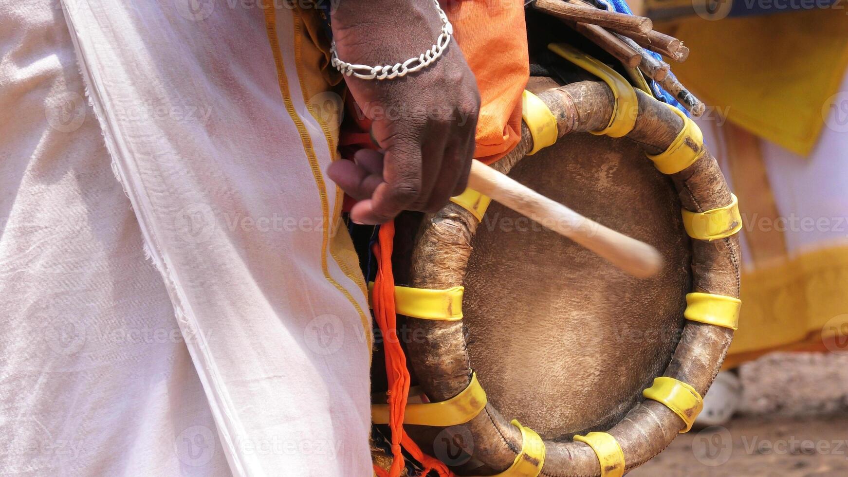 An artist playing Thavil, a South Indian traditional musical instrument photo
