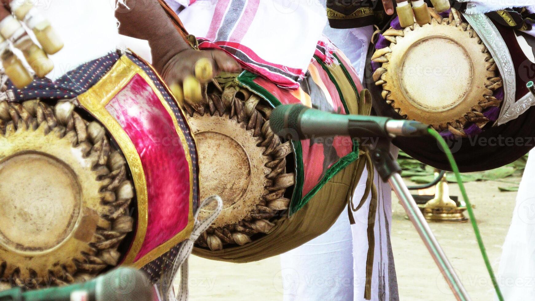 An artists playing Maddalam, a South Indian traditional musical instrument photo