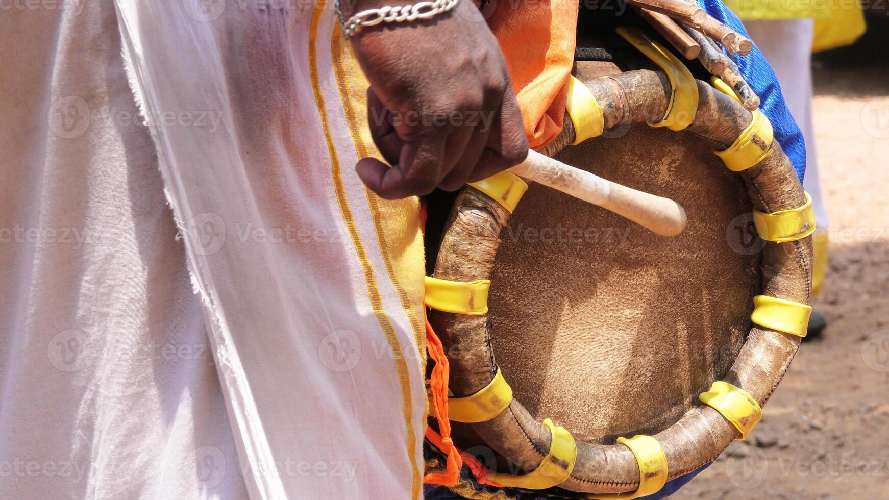 An artist playing Thavil, a South Indian traditional musical instrument photo