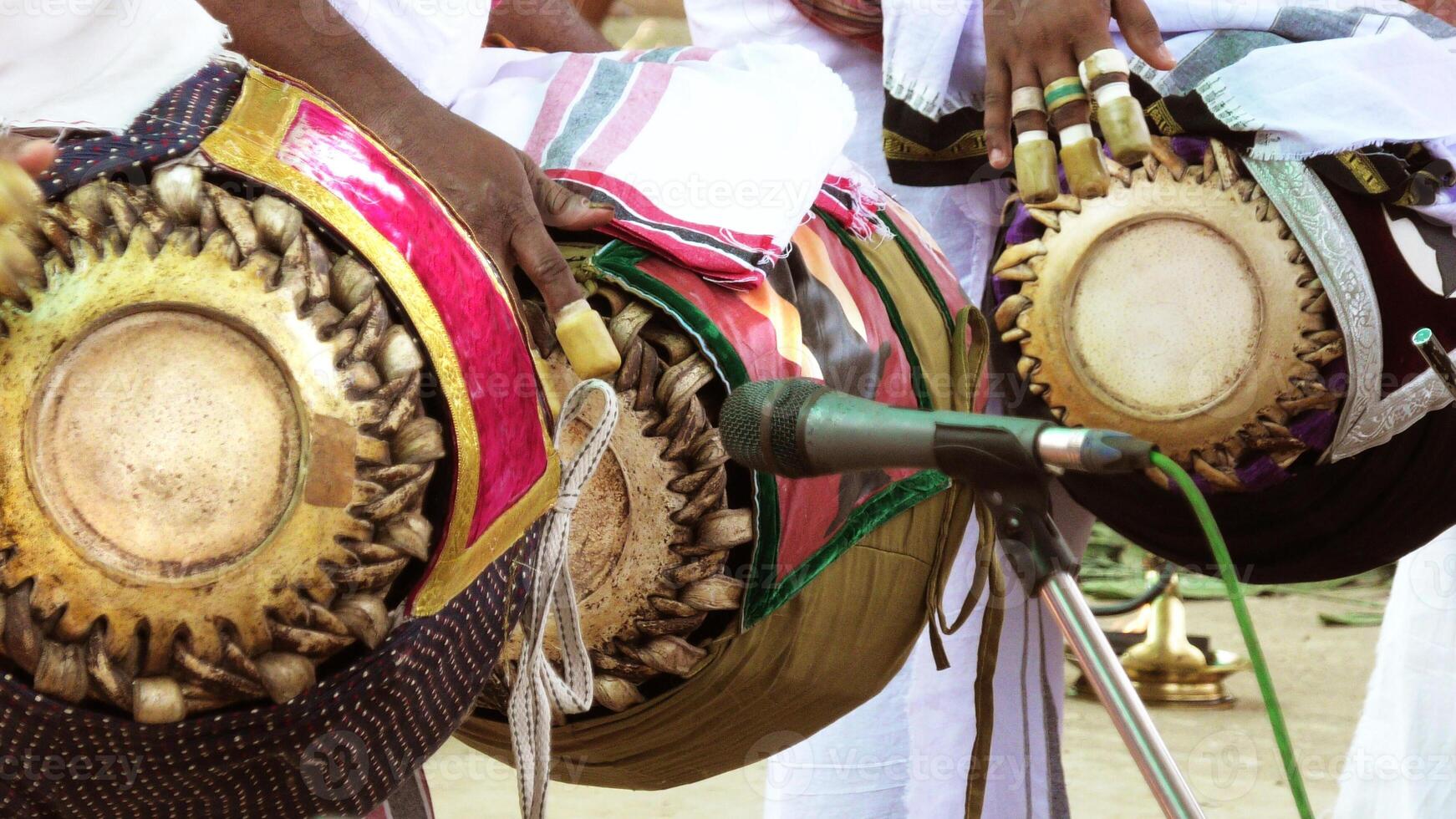 An artists playing Maddalam, a South Indian traditional musical instrument photo
