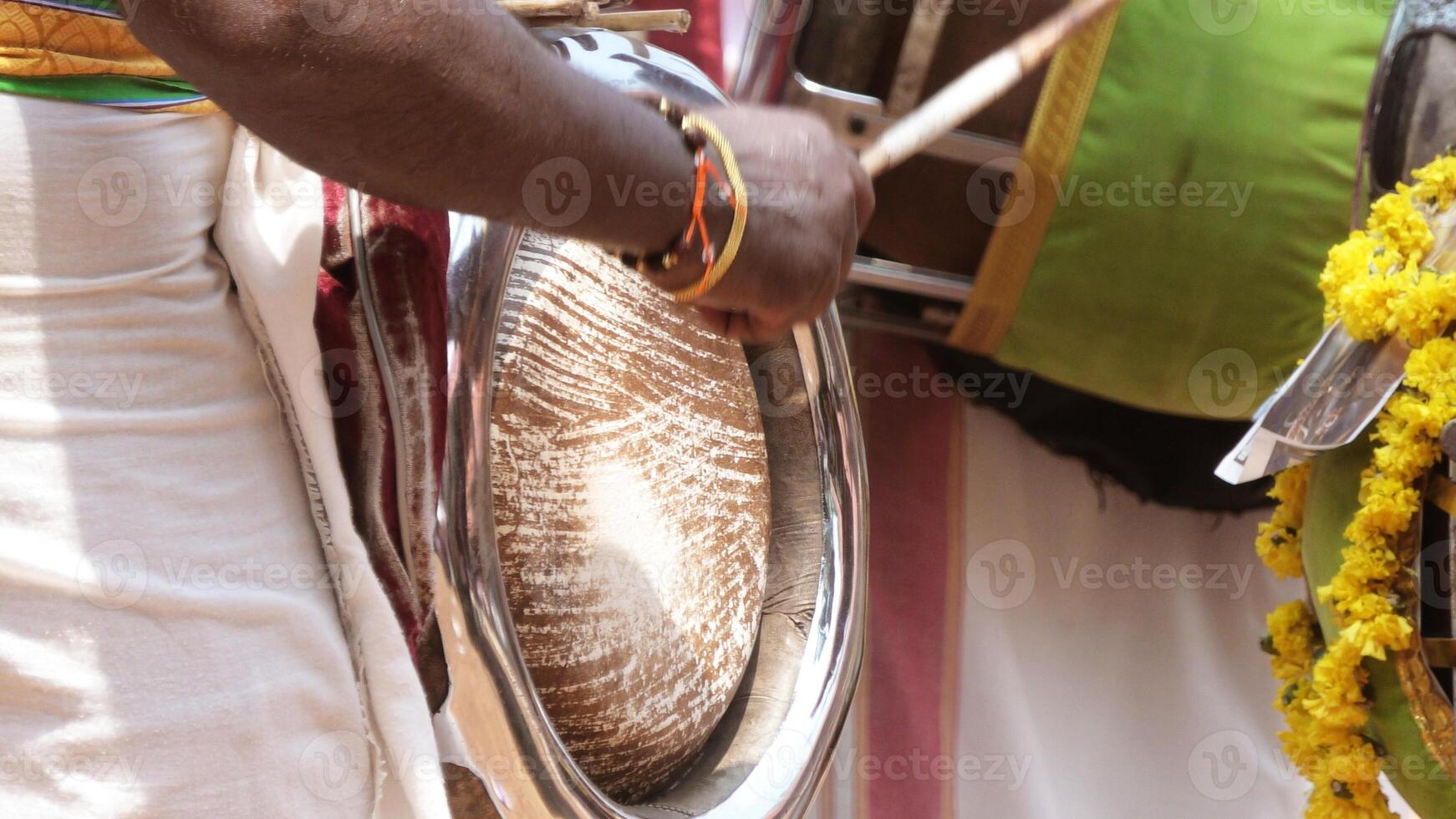 An artist playing Thavil, a South Indian traditional musical instrument photo