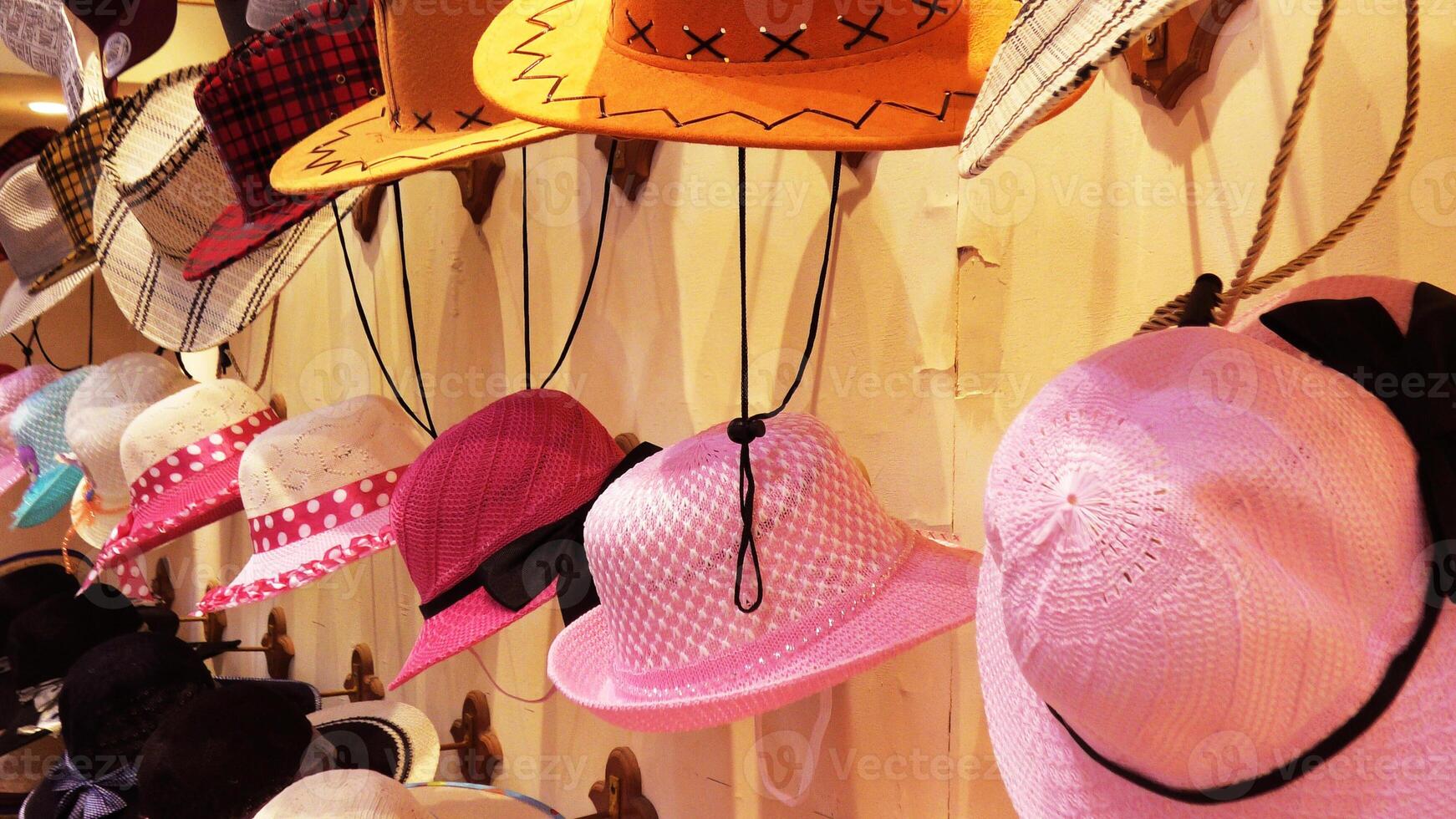 Colorful hats displayed in a street shop photo