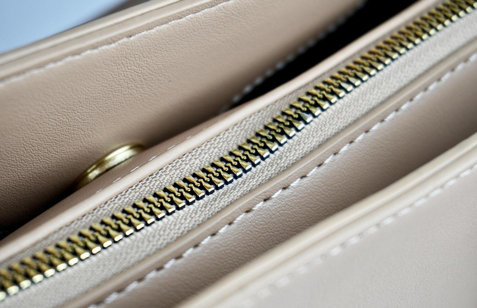 Close up part on hand bag zipper and round magnet lock snap parts. Object detail photography isolated on horizontal background. photo
