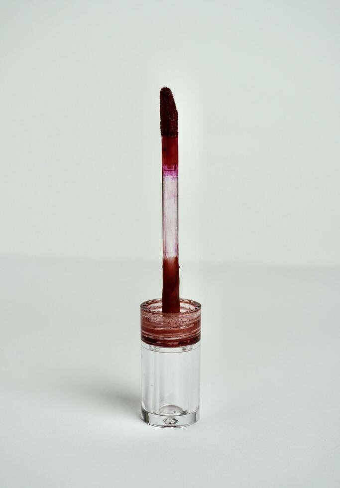 Lip tint brush. Beauty lip product object photography isolated on vertical white background. photo