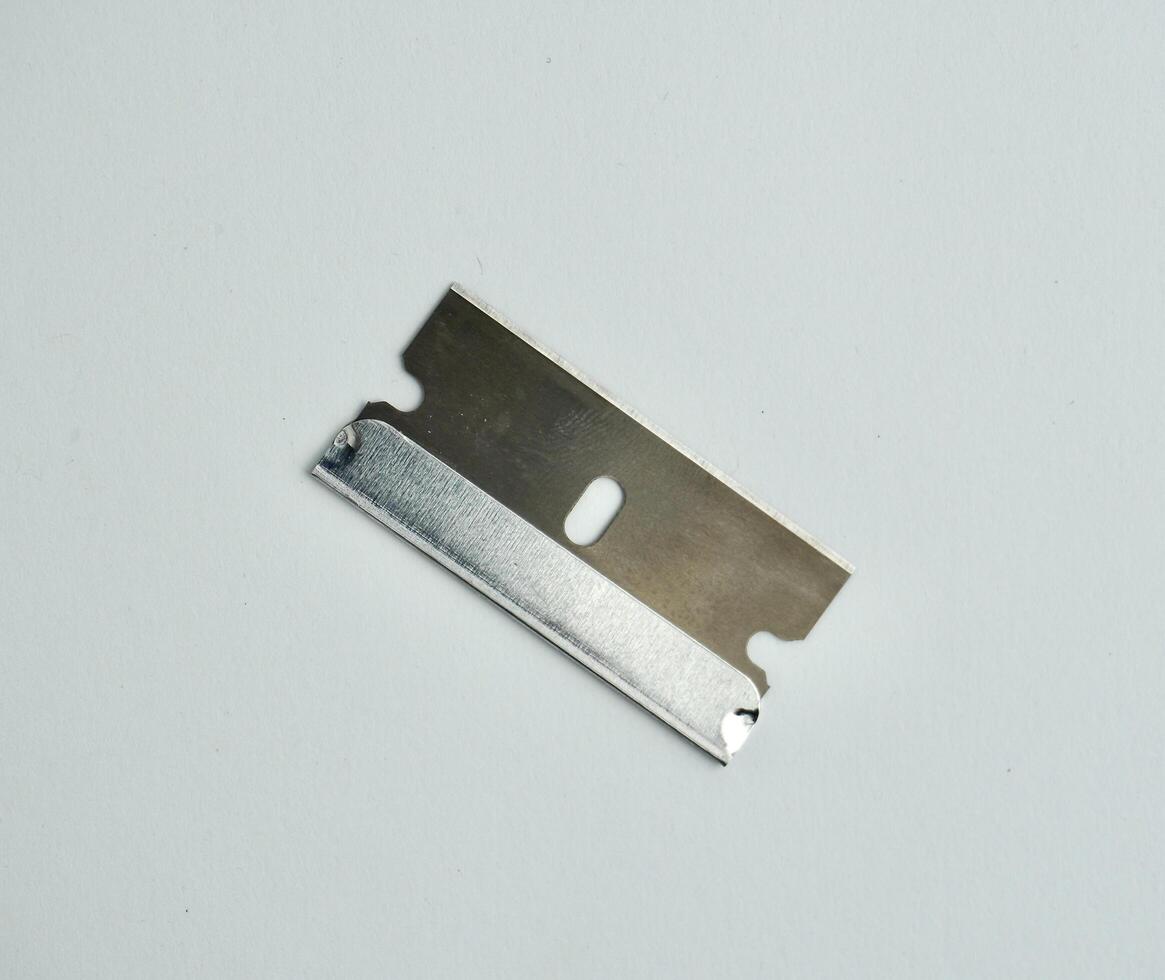 One piece of steel razor blade object photography isolated on white background. photo