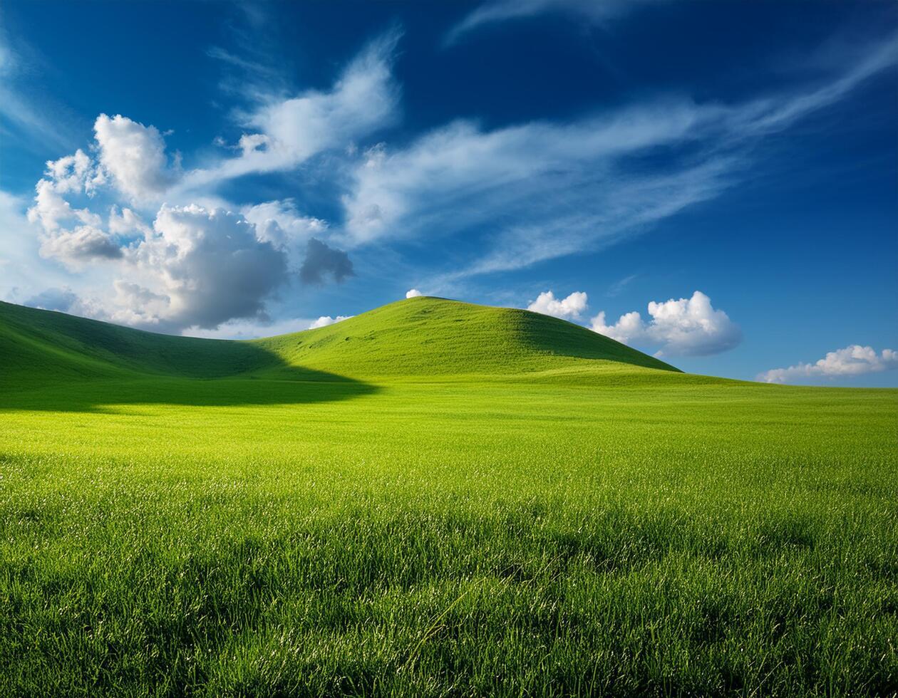 Green meadow with hill under the cloudy blue sky landscape photo