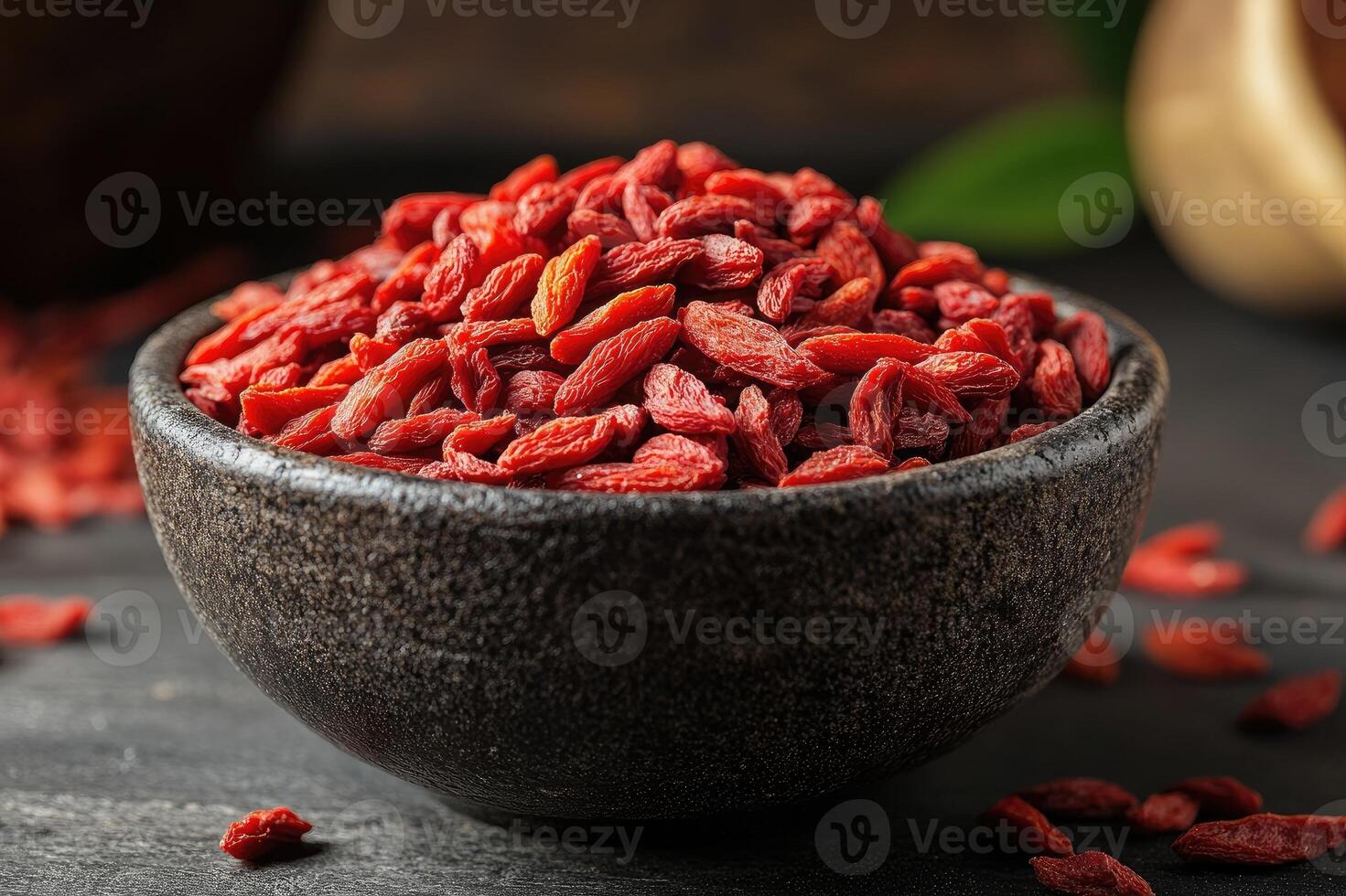 Bowl full of healthy, dried goji berries is overflowing photo