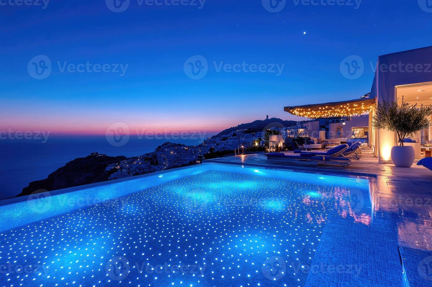 Infinity pool overlooking picturesque cityscape of santorini at twilight photo
