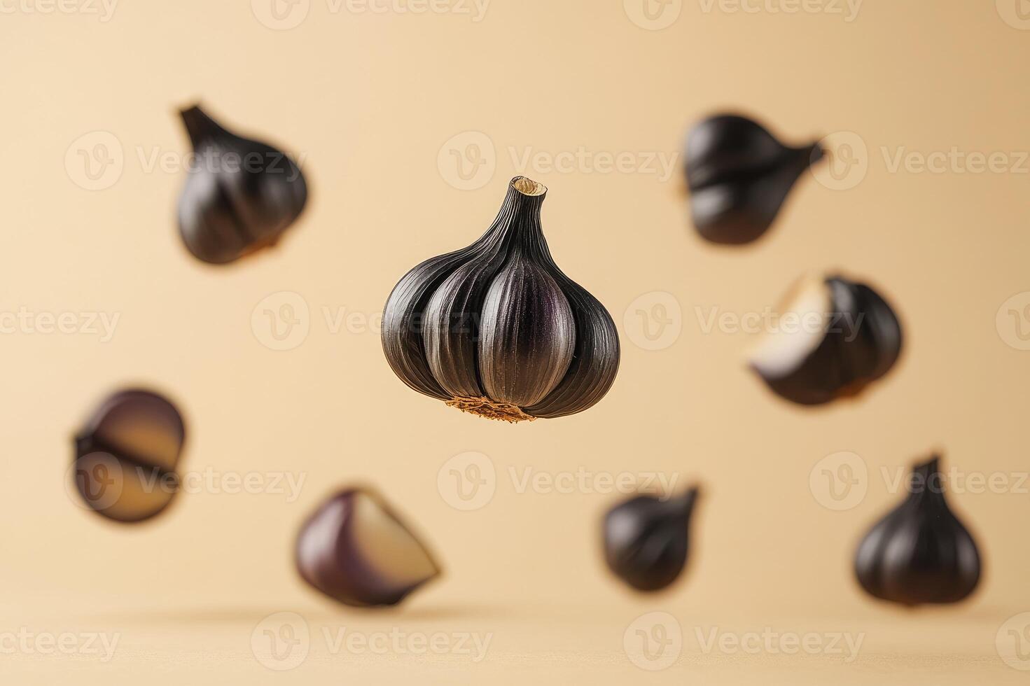 Black garlic bulbs floating on a minimal background photo