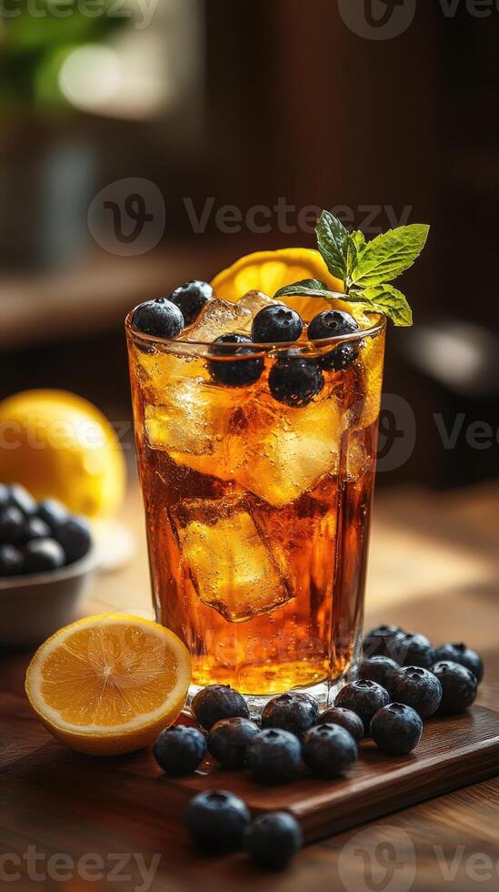 Iced tea garnished with blueberries and lemon slices on a wooden table photo