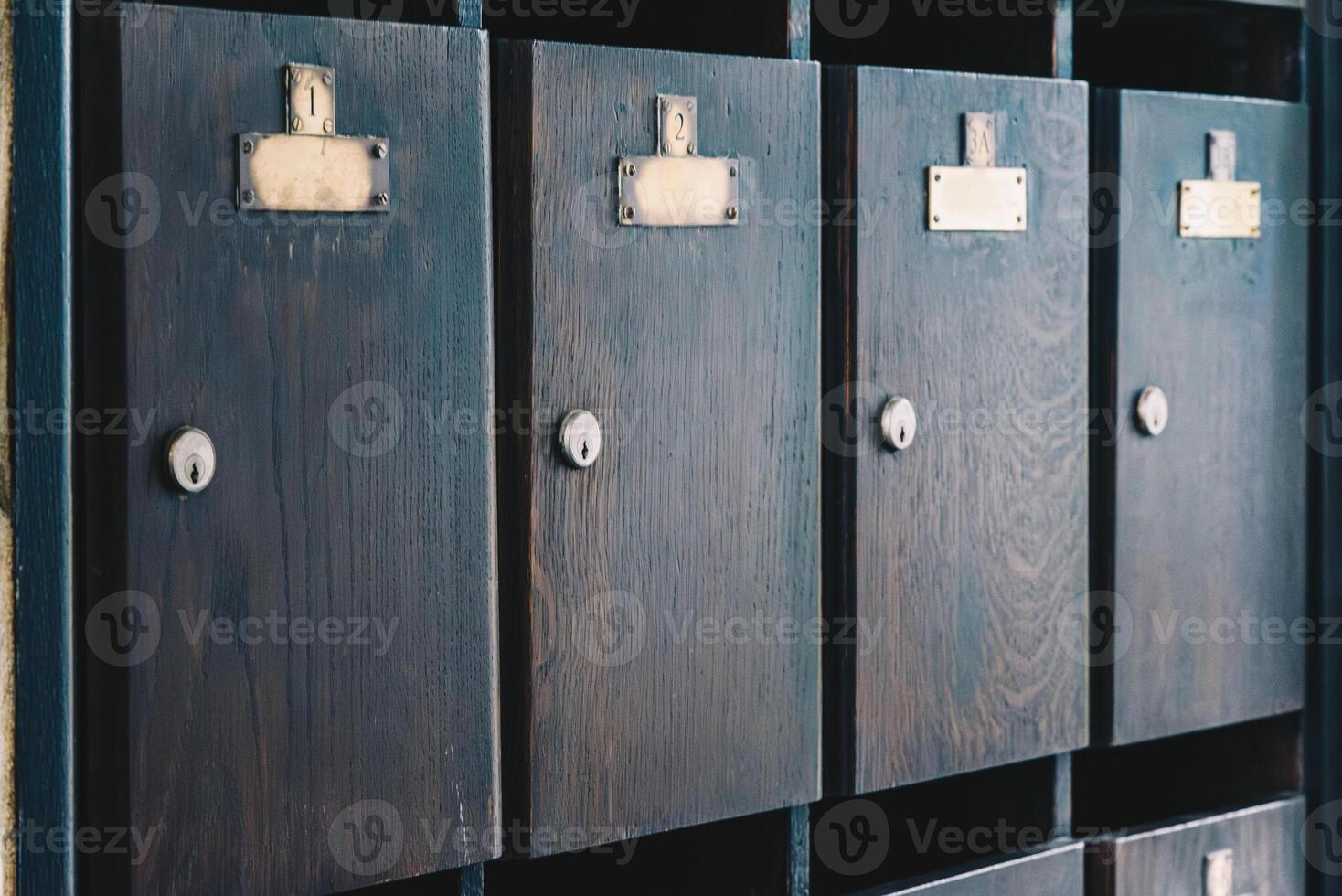 Old wooden mailboxes with empty name tags photo