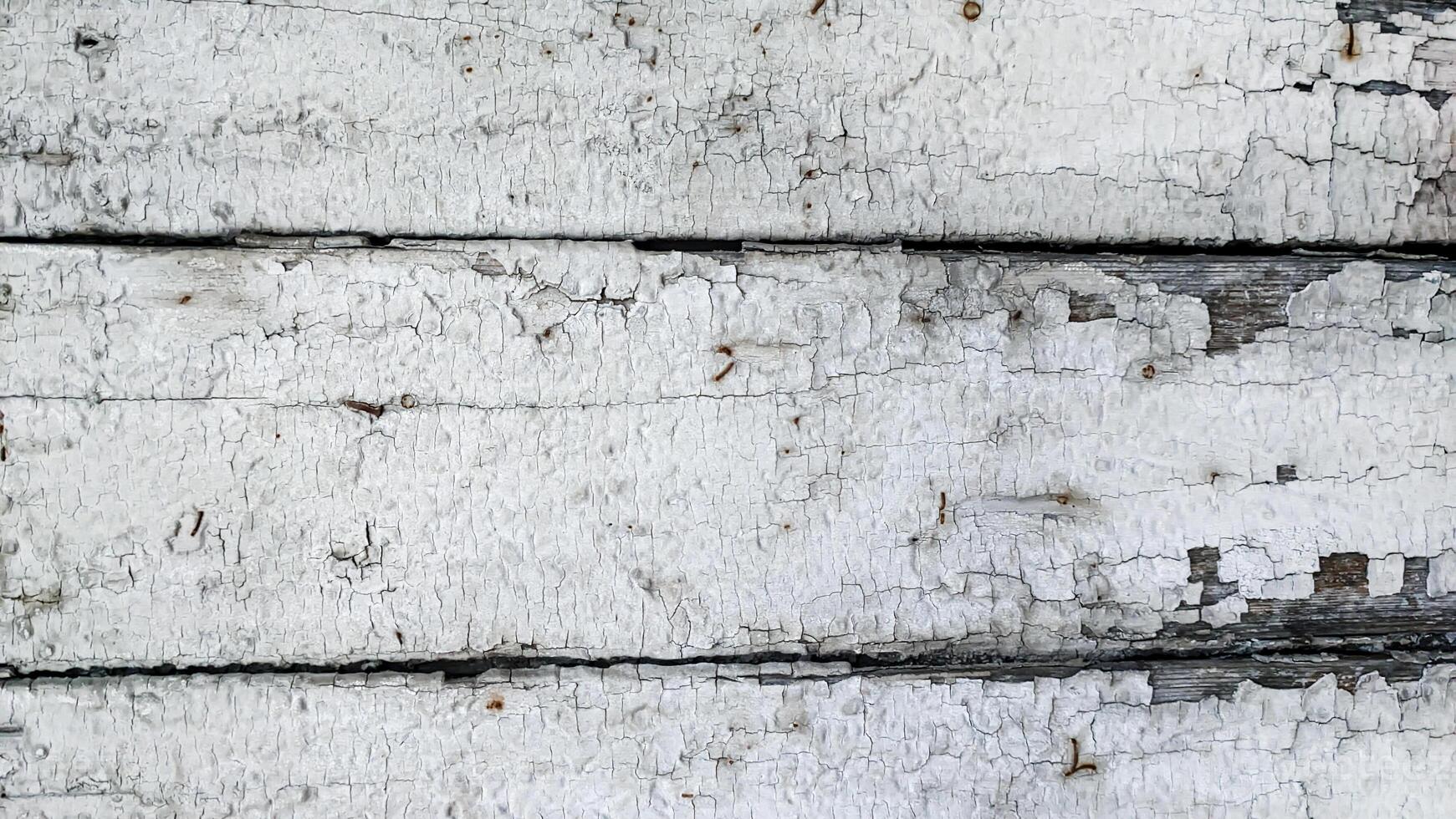 Wooden boards white with gray with old peeling paint, horizontal in full frame top view. Background texture photo