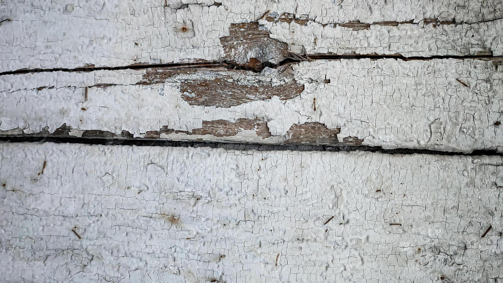 Wooden boards white with gray with old peeling paint, horizontal in full frame top view. Background texture photo