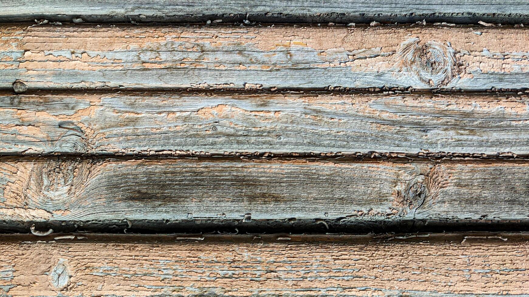 Wooden planks brown with old peeling paint, horizontal full frame top view. Background texture photo