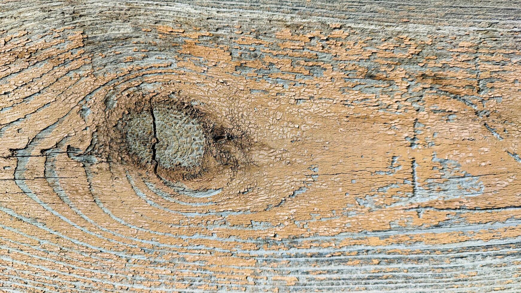 Saw cut of a board brown with a texture of wood with old peeling paint, horizontal in full frame view from above. Photo of a background texture