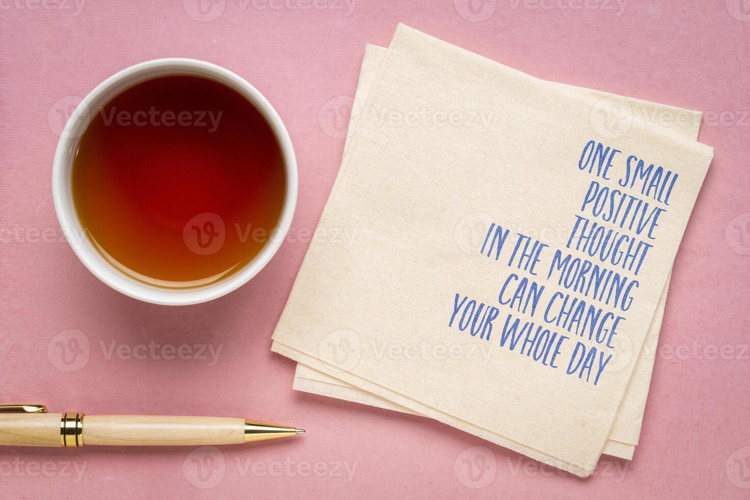 One small positive thought in the morning can change your whole day - inspirational handwriting on a napkin, positivity concept photo