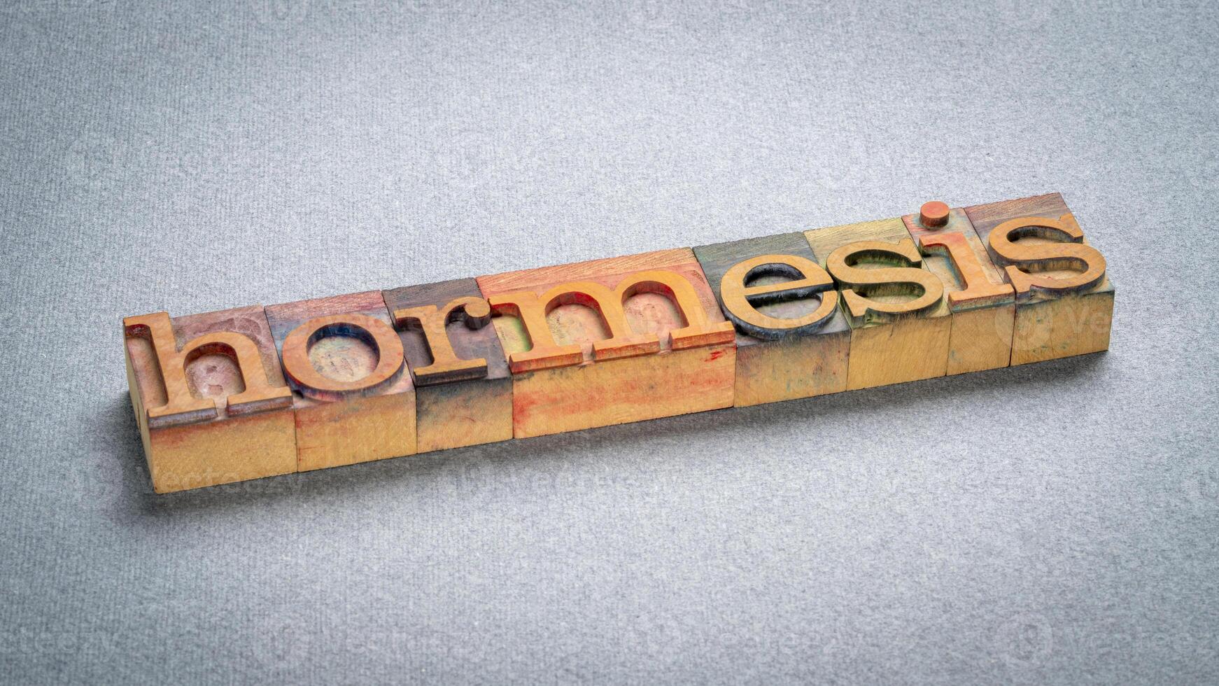 hormesis word in letterpress wood type, biological phenomenon where exposure to low doses of a stressor or toxin can have a beneficial effect on an organism photo