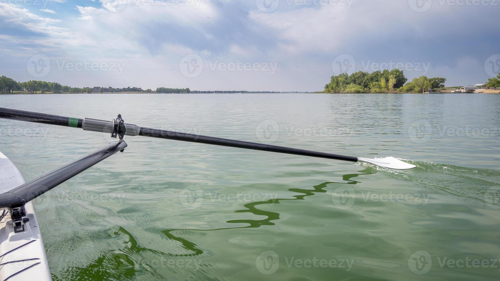 hatchet sculling oar on a calm lake, Boyd Lake in Colorado photo