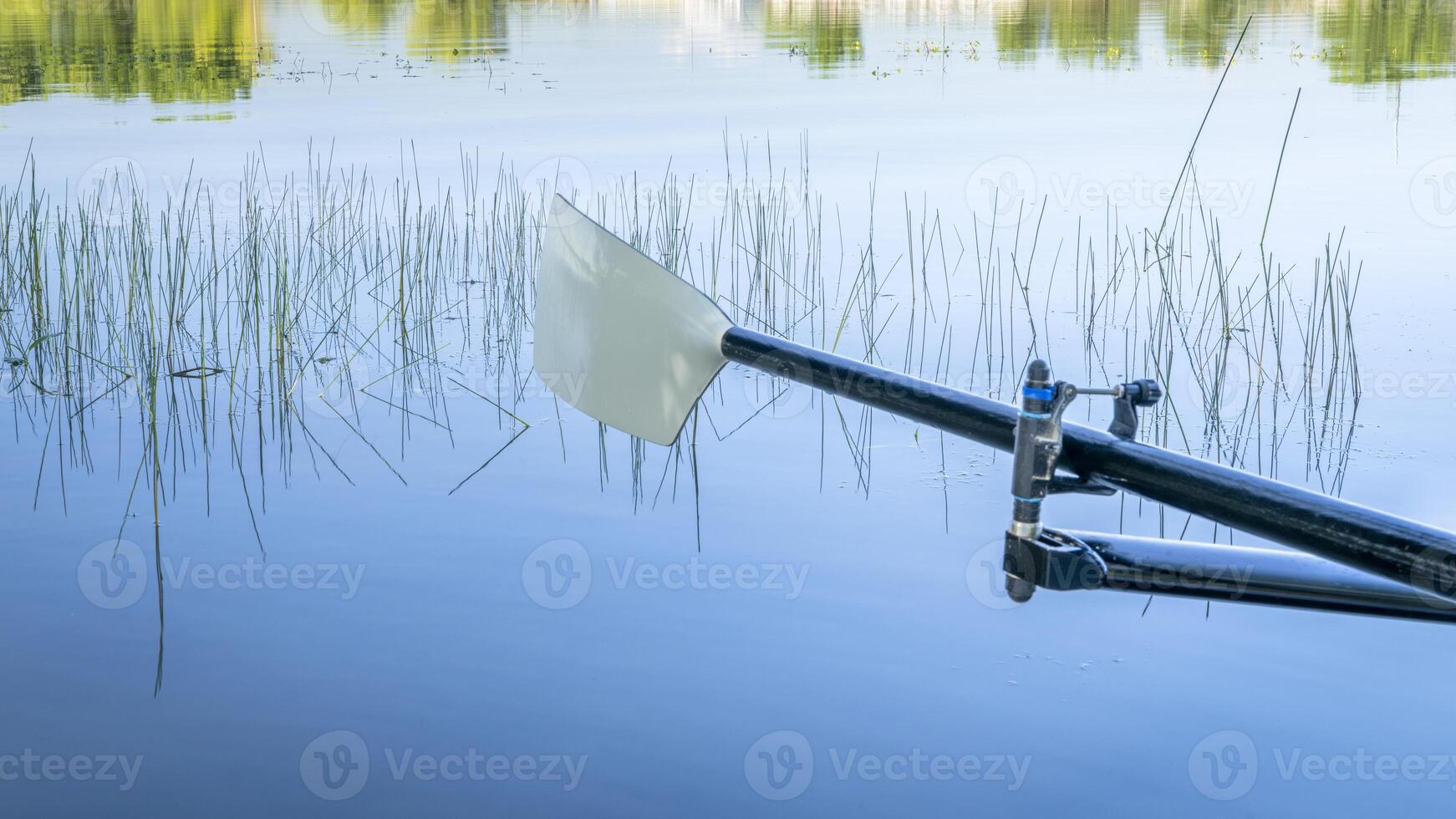 hatchet sculling oar on a calm lake, Boyd Lake in Colorado photo
