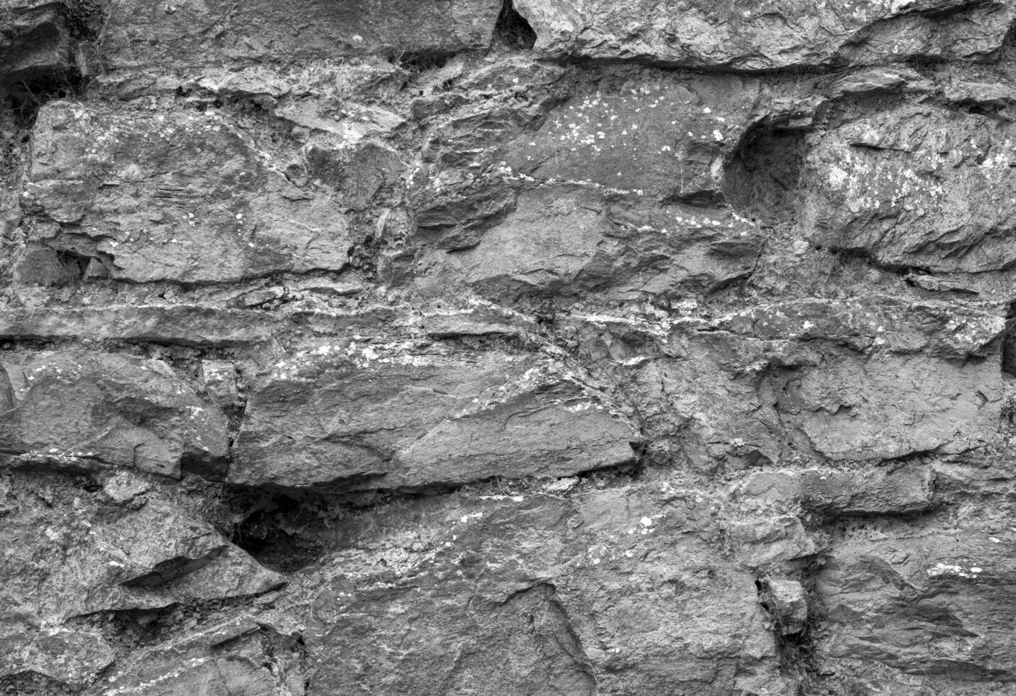 Stone wall pattern, natural stone texture, ground pavement background. Black and white photo background