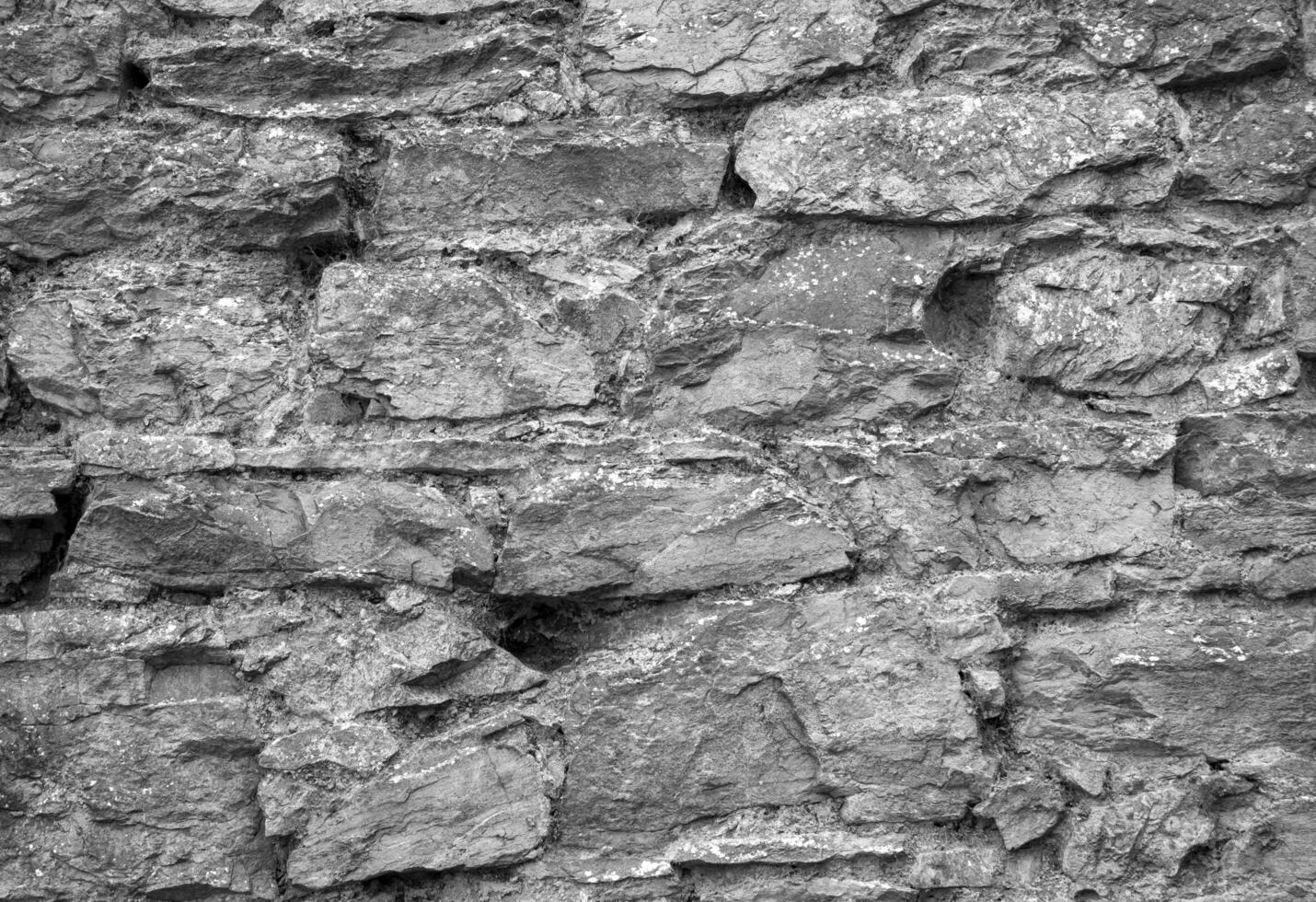 Stone wall pattern, natural stone texture, ground pavement background. Black and white photo background