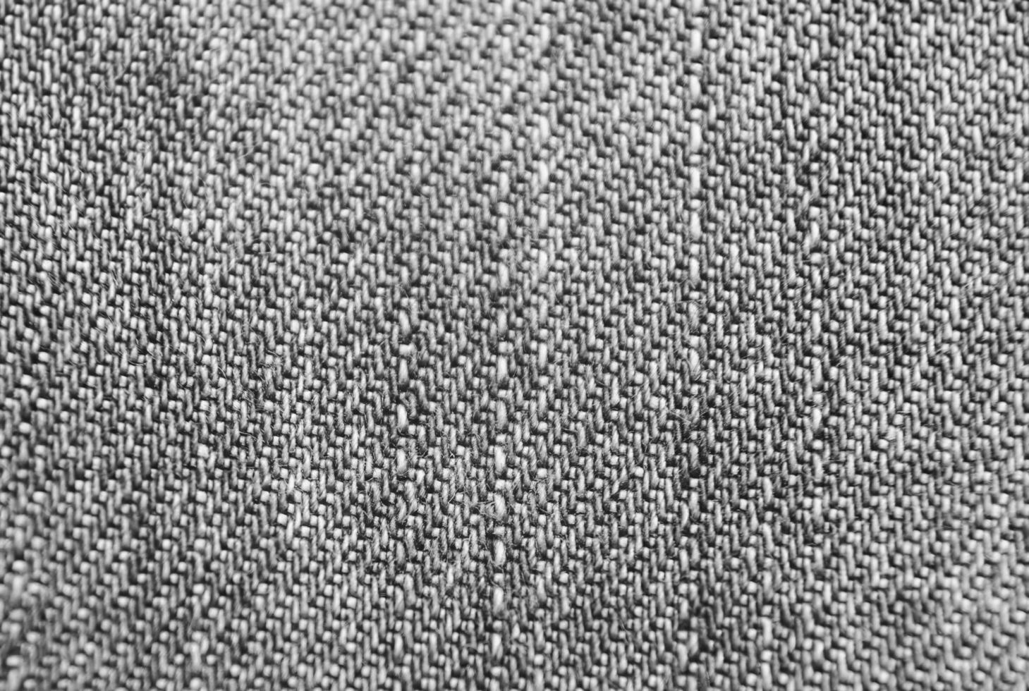 Blue jeans cloth texture close view. Black and white monochrome grayscale photo background.