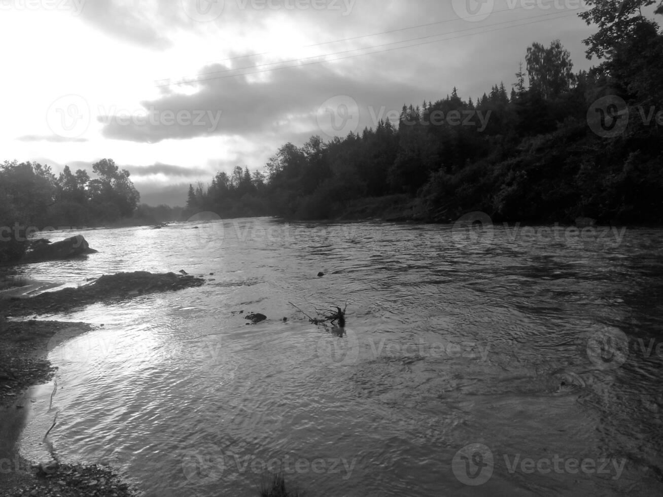 Mountain river and morning mist. Black and white monochrome photo