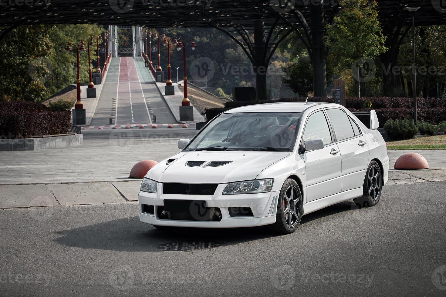 White car on a street background. Modern city sport car with a spoiler wallpaper photo