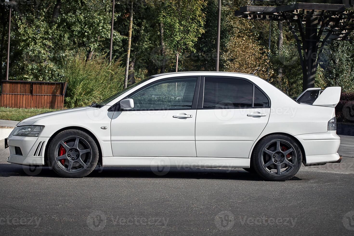 White car on a street background. Modern city sport car with a spoiler wallpaper photo