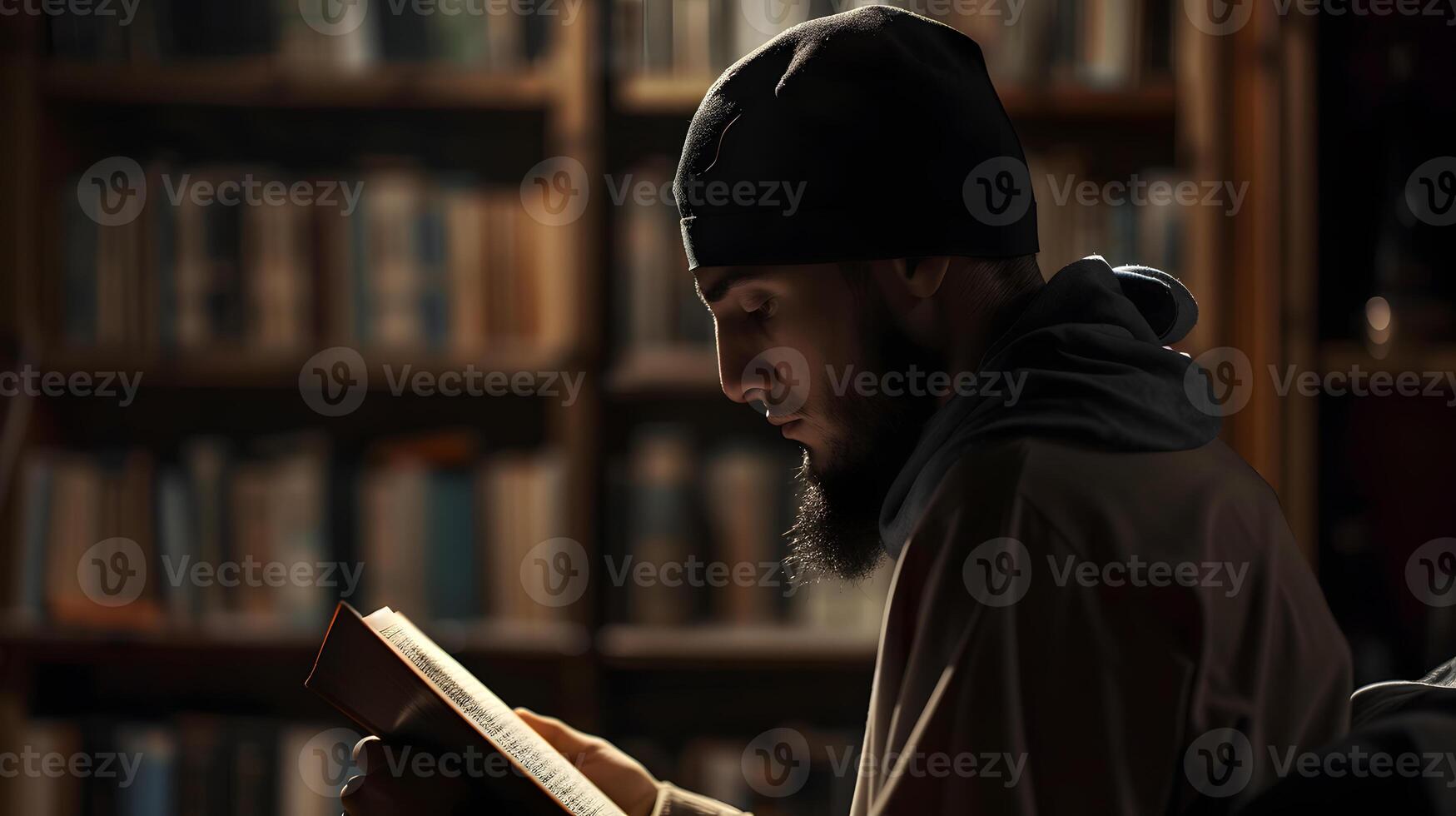 A Muslim man is reading the Quran in a peaceful setting with a dim and serene nighttime background. photo