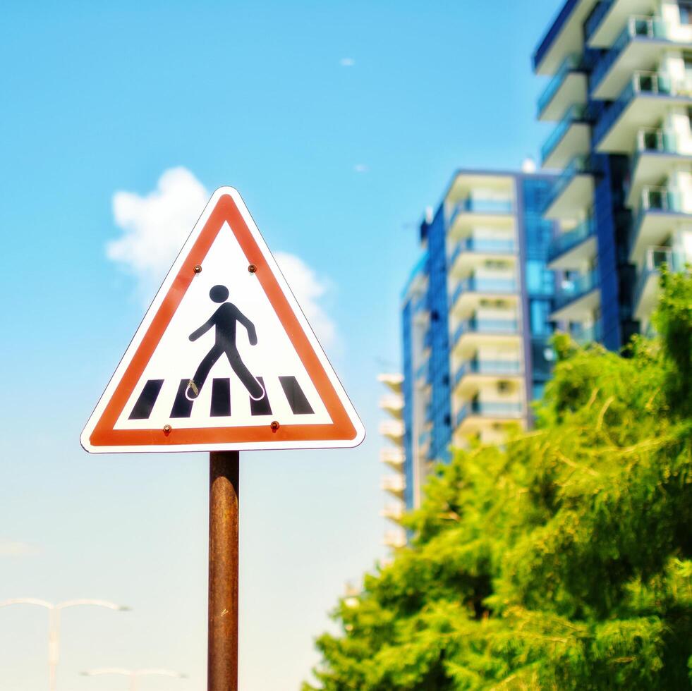 Urban landscape with a zebra crossing triangle road sign photo