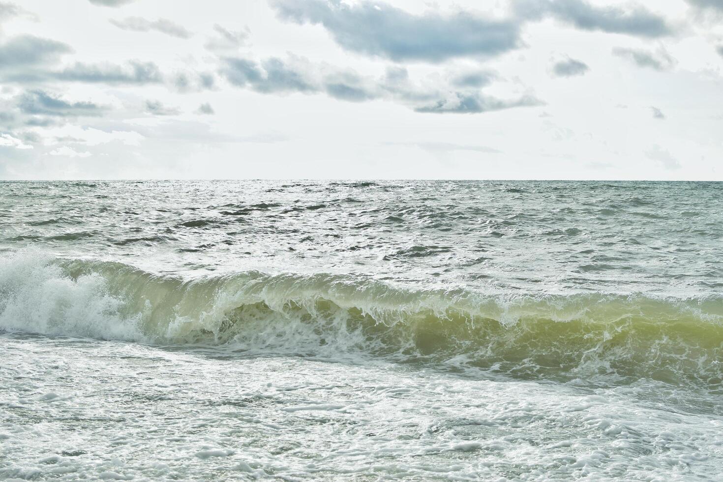 Big waves in the sea. Beautiful sea with splashes under the bright morning sunlight. photo