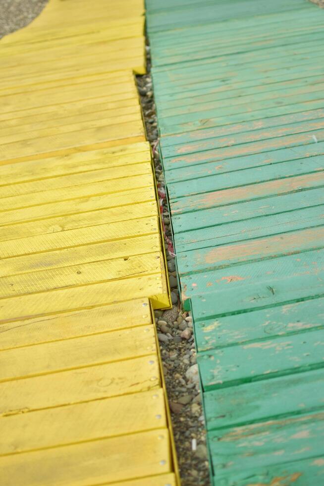 Green and yellow board way on the beach photo