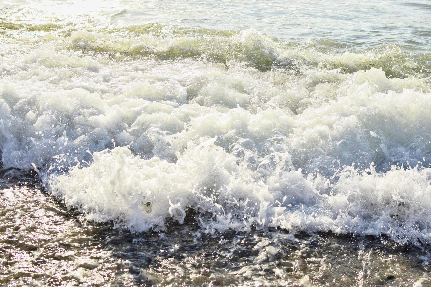 Big waves in the sea. Beautiful sea with splashes under the bright morning sunlight. photo
