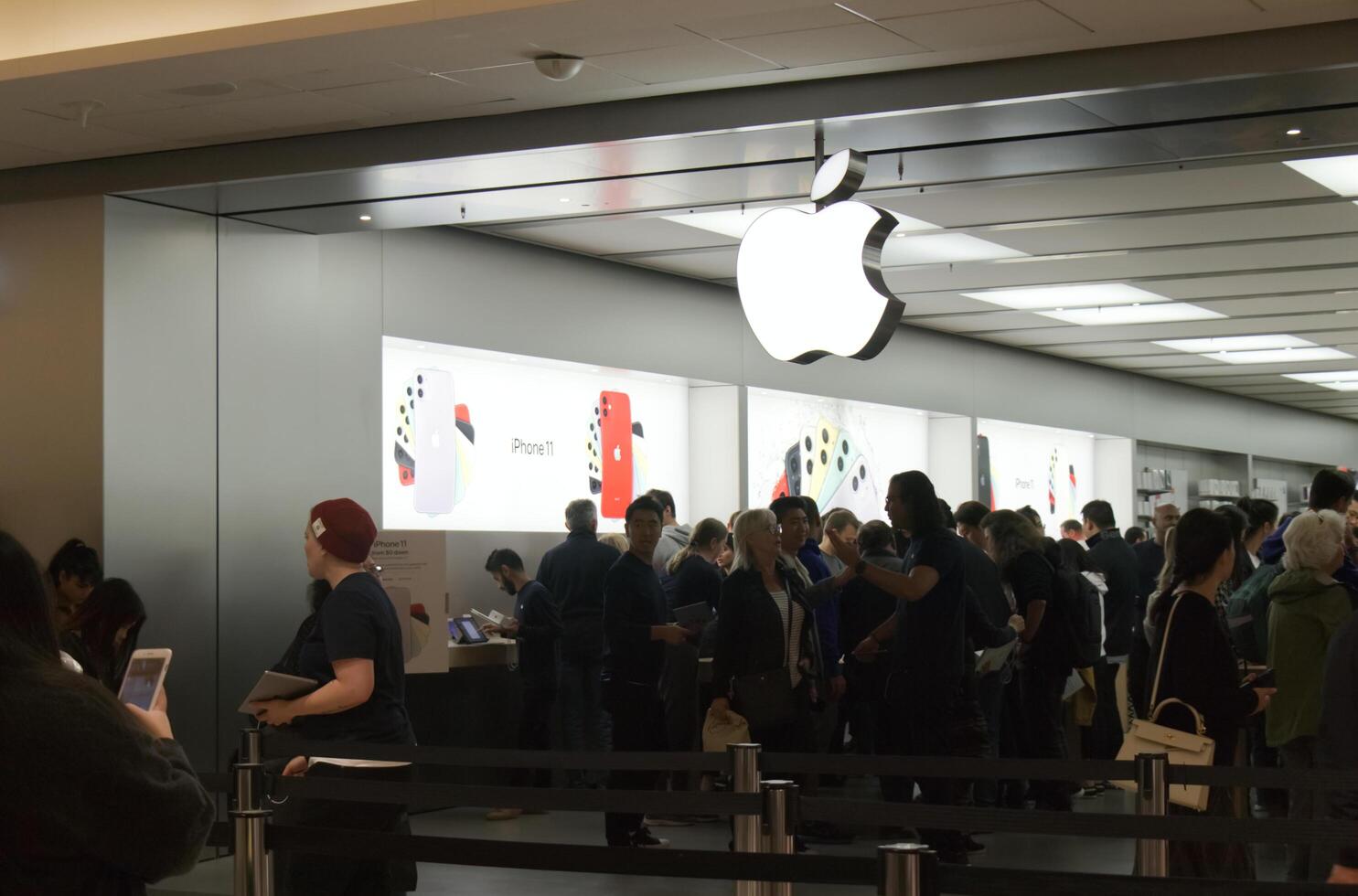 Vancouver, Canada - September 20,2019 Apple officially started selling the iPhone 11 and iPhone 11 Pro. Apple Store is crowded with people waiting for their new iPhones to buy photo