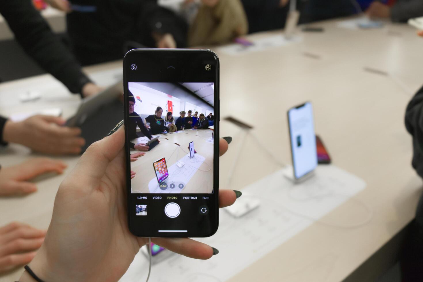 Vancouver, Canada - September 20,2019 Apple officially started selling the iPhone 11 and iPhone 11 Pro. Woman is holding iPhone 11 Pro showing the amazing ultra wide angle camera at local Apple Store photo
