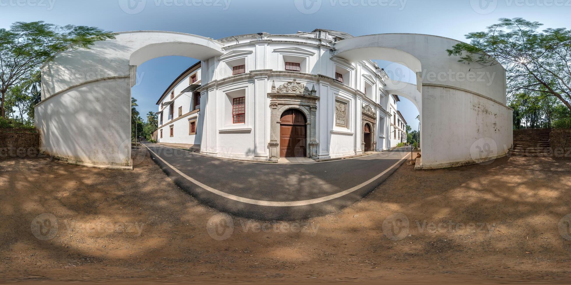 full hdri 360 panorama of portugese catholic church with arches in jungle among palm trees in Indian tropic village in equirectangular projection with zenith and nadir. VR AR content photo