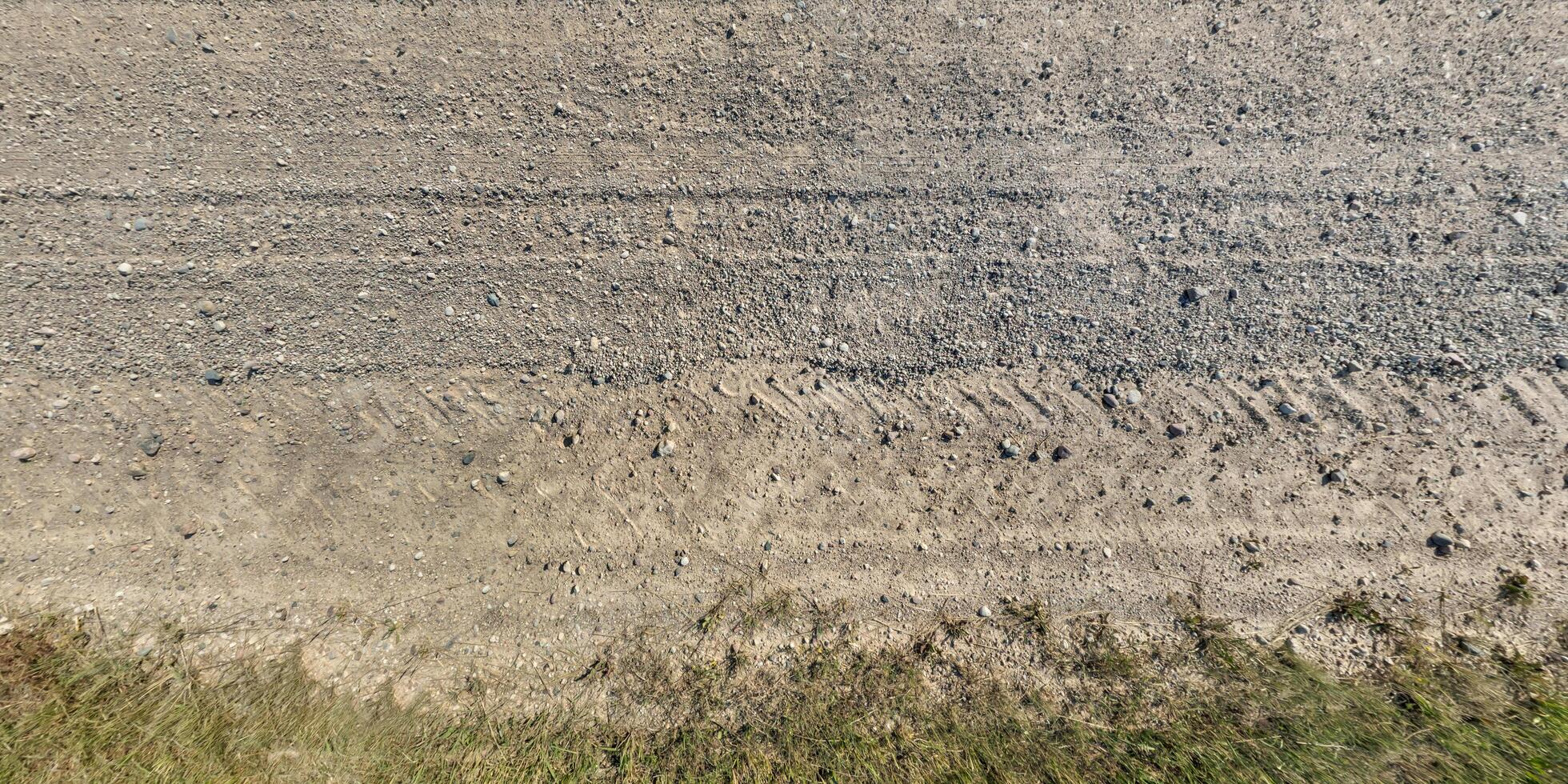 view from above on texture gravel road with median with lawn photo